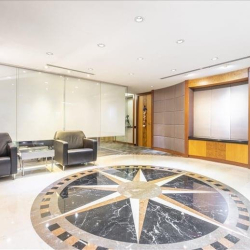 Office lobby with a compass rose floor design and leather armchairs, Wanchai, Hong Kong